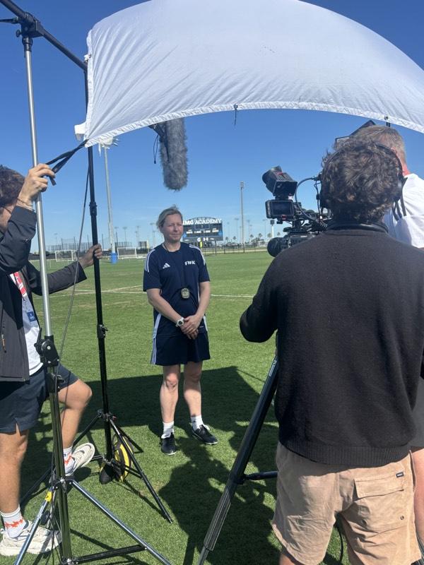 On-set interview setup filming outdoors at a stadium