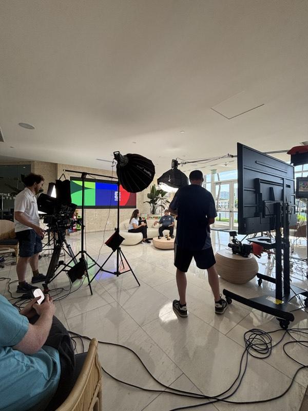 Full production crew filming a seated interview