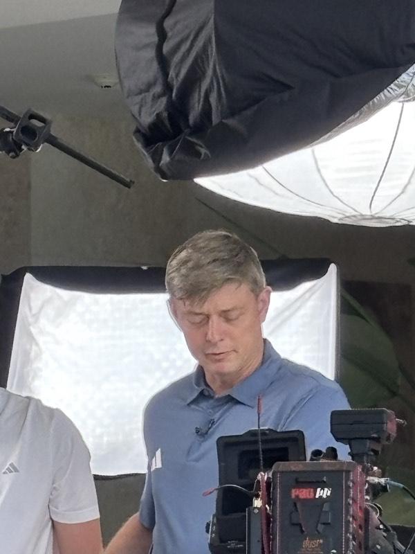 Close-up of a presenter between takes on set