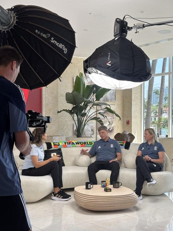 Lighting rig and crew setting up an indoor interview